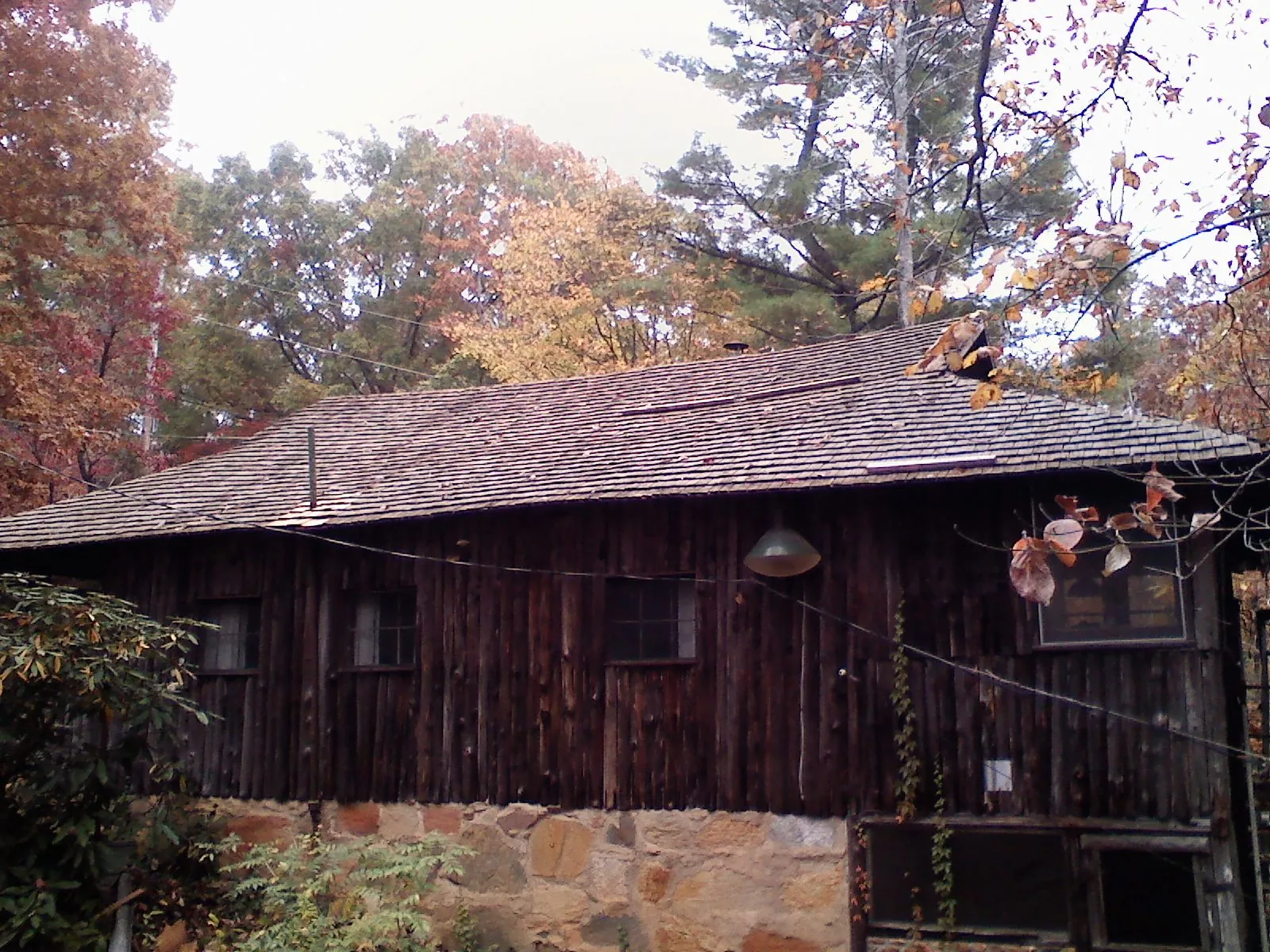 Weathered wood shake roof on a rustic board sided cabin in Leavittsburg
