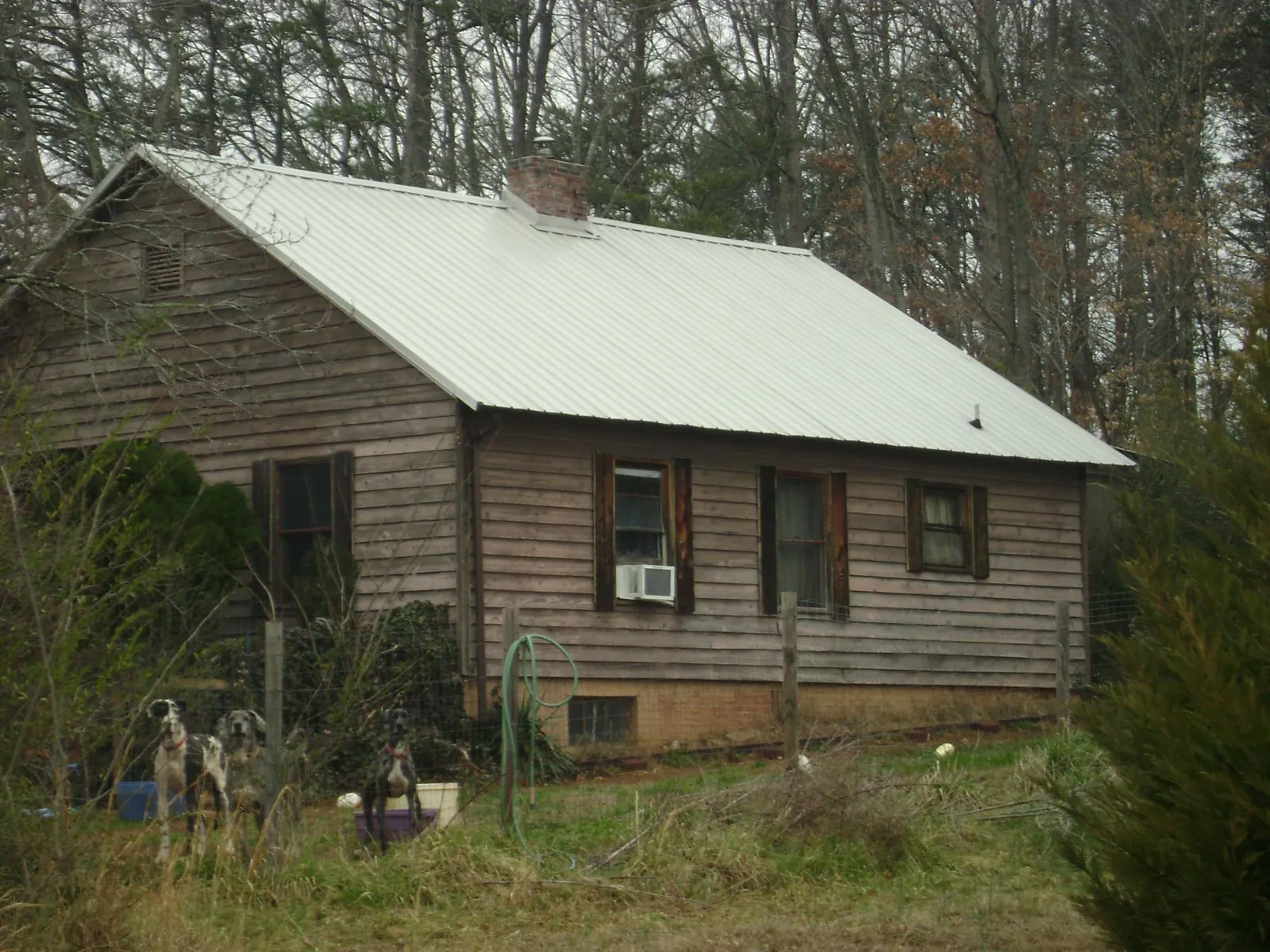 White metal roof on an old wood sided farmhouse, from a Metal Roof Installation job in Leavittsburg
